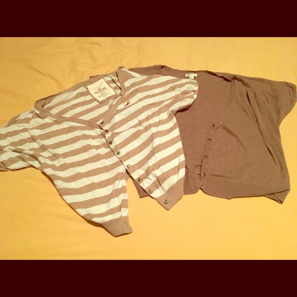 Two short sleeve sweaters/cardigans.